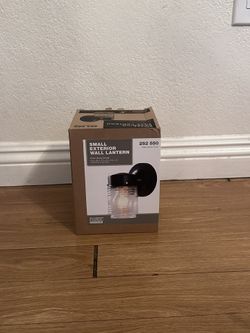 Small Exterior Wall Lantern with a matte black finish and clear glass shade. 