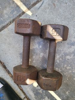 vintage, unbranded 15 lb cast iron dumbbells featuring heavy surface rust