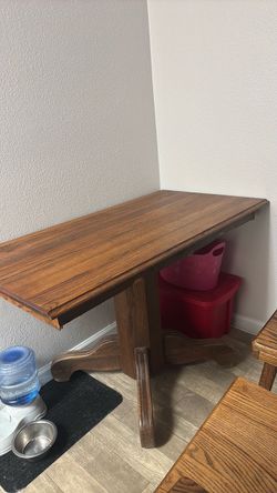 Brown wood table with three chairs