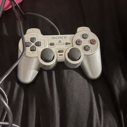 silver PlayStation 2 DualShock 2 controller