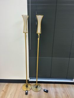 two matching gold floor lamps
