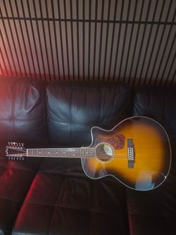 12 string Guild jumbo acoustic guitar with travel case