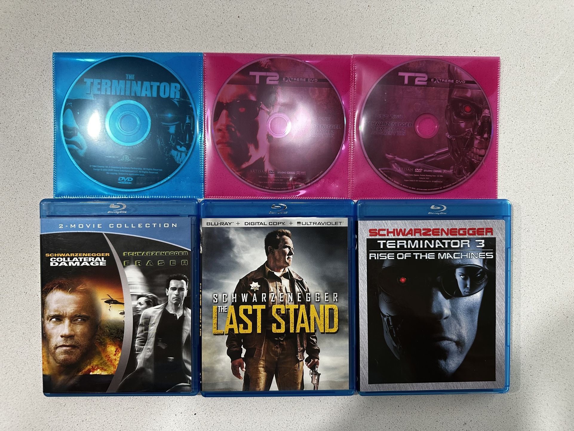 Set Of Blue-Ray And DVD Movies Starring Arnold Schwarzenegger.
