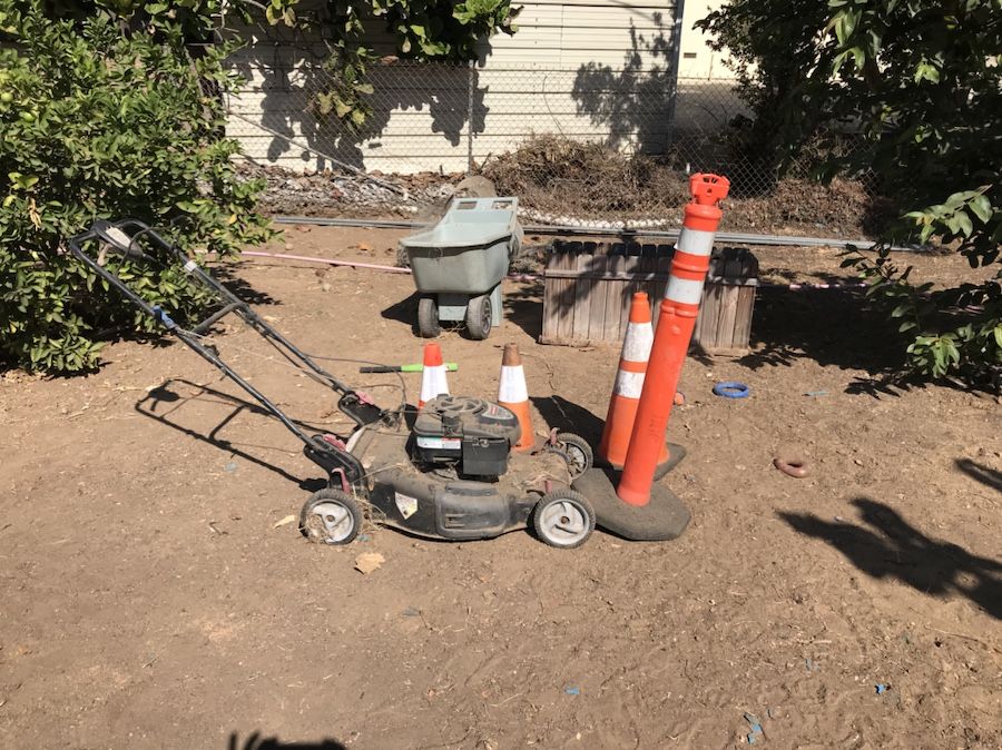 Lawn mower and orange cones