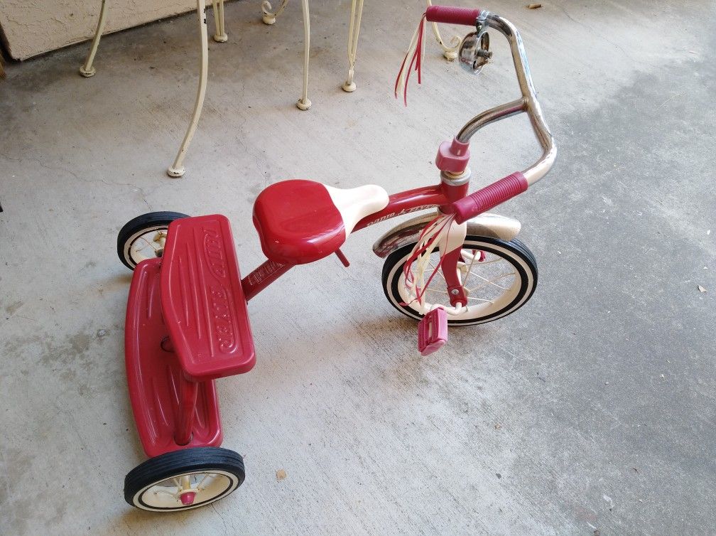 Red radio flyer old school tricycle.