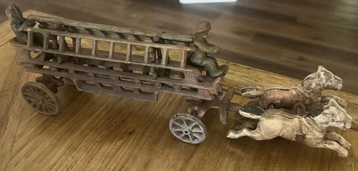 Antique cast iron horse drawn fire fighters with ladders. Metal art, toy, Christmas 