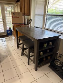 Ashley Furniture counter-height dining table with 4 matching stools.