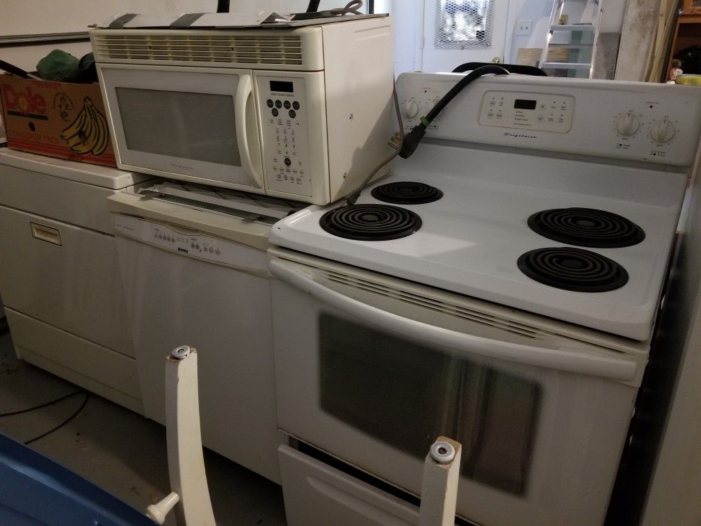 Frigidaire stove with microwave vent, refrigerator and dishwasher. A landlord's dream a whole kitchen appliance set ready to go,