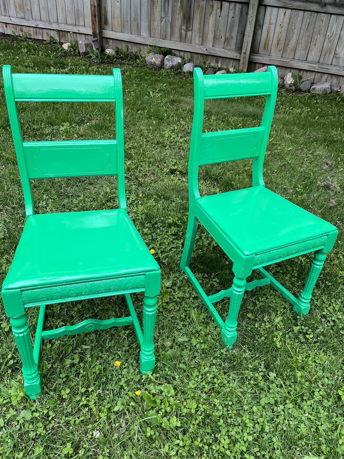two green antique statement chairs