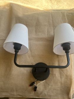 Dual wall lamps, black fixture, white shade