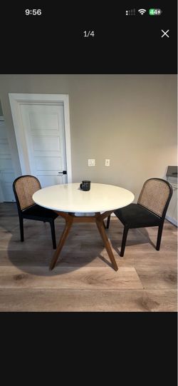White Round Dining Table with Rattan Chairs