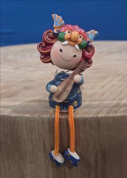 Polymer Clay Souvenir Doll featuring a "lion-biting-sword" design from  Taiwan, used as a protective amulet