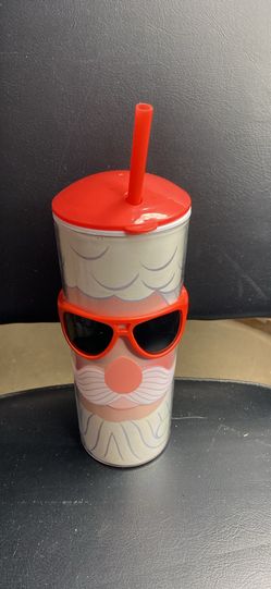 Cup with glasses and straw