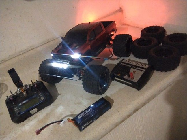 traxxas stampede 4x4 brushed, 2 lipo batteries charger, and 2 set of wheels