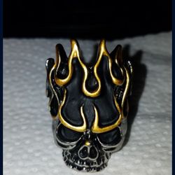 Size 9 solid Stainless steel with 18kt. GP on the flames. Flaming Skull ring.