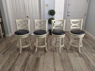Four beautiful counter height swivel bar stools