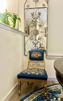 Antique  embroidered accent chair on coasters . 