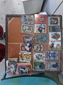 16 football and baseball cards in cases and a whole bunch not