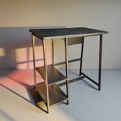 Black tall stand up desk / bar table. Good condition. Measurement: 24 deep x 42 L x 42H.