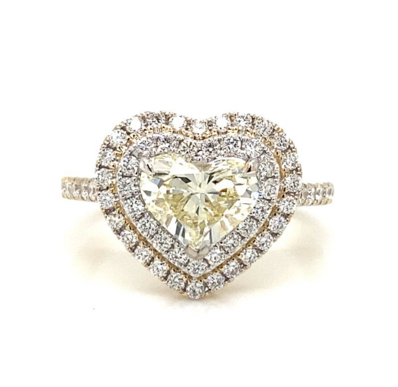 Designs 18K Double Halo Diamond Ring 💍❤️🤙🏾  18K yellow gold diamond ring. The center is set with a 1.23 carat heart shaped diamond, which has a cla