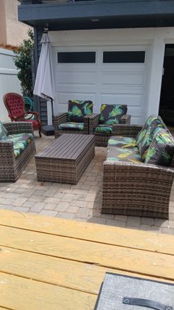 outdoor patio set. chairs couches and umbrella