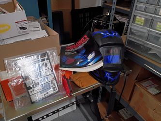 Welder with helmet and book