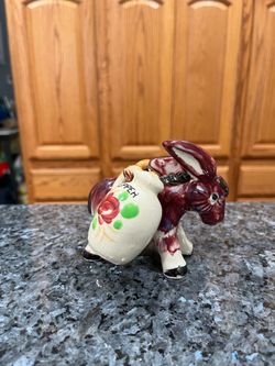 Vintage 1950's Ceramic Donkey with pair of Salt and Pepper Shakers hanging on the donkey.  Preowned missing stoppers
