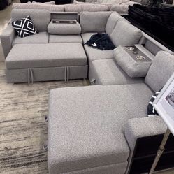 Beautiful Sectional Pull Out Bed With Storage And Cup holders 