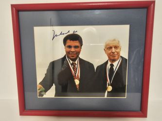Muhammad  Ali  autographed  photo wearing  Olympic gold medal with Joe Diamaggio, includes autographed  boxing gloves and books about him
