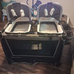 Baby Trend double twin bassinet with changing table plus mattresses.
