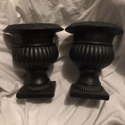 Two black urns pots with two pot huggers all together