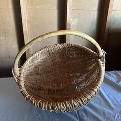 vintage hand-woven rattan gathering basket, better known as “buttocks" or "melon" basket