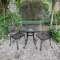 Wrought iron bistro set with cushions