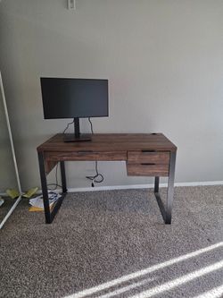 Beautiful walnut-colored desk with drawers and black metal legs