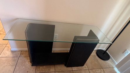 Modern glass top console table with black and gold base