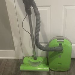 The Kenmore 116 is a lime green canister vacuum with cord rewind and HEPA filters. It is a bagged vacuum with included accessories and a corded power 
