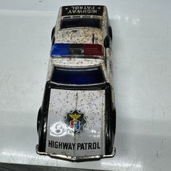 Highway Patrol Tin Car Works 1960’s. 10” L x 4” W x 3 1/2” H. Will Ship At Buyers Expense