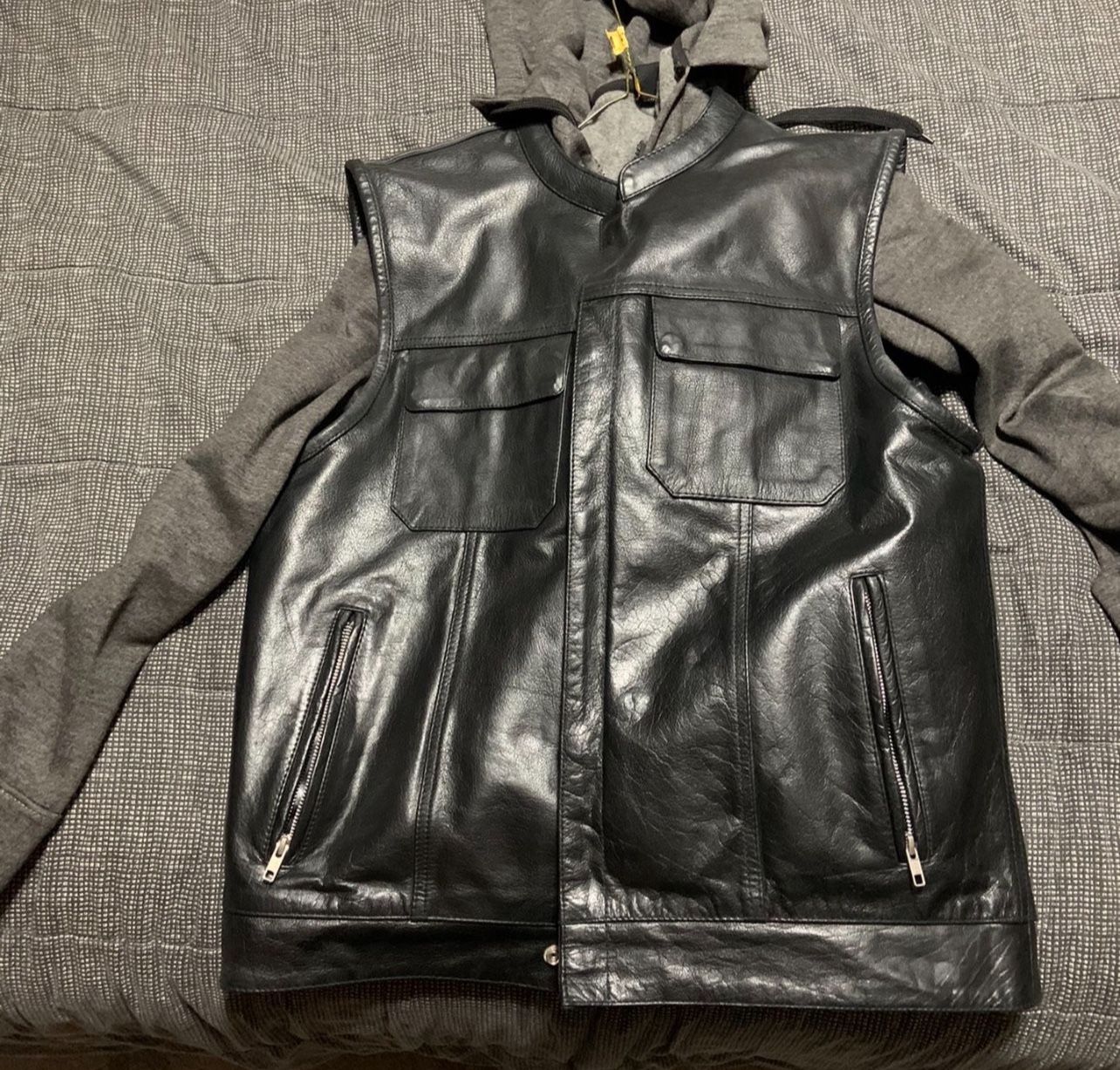 Size Large. Black leather motorcycle vest with concealed gun pockets