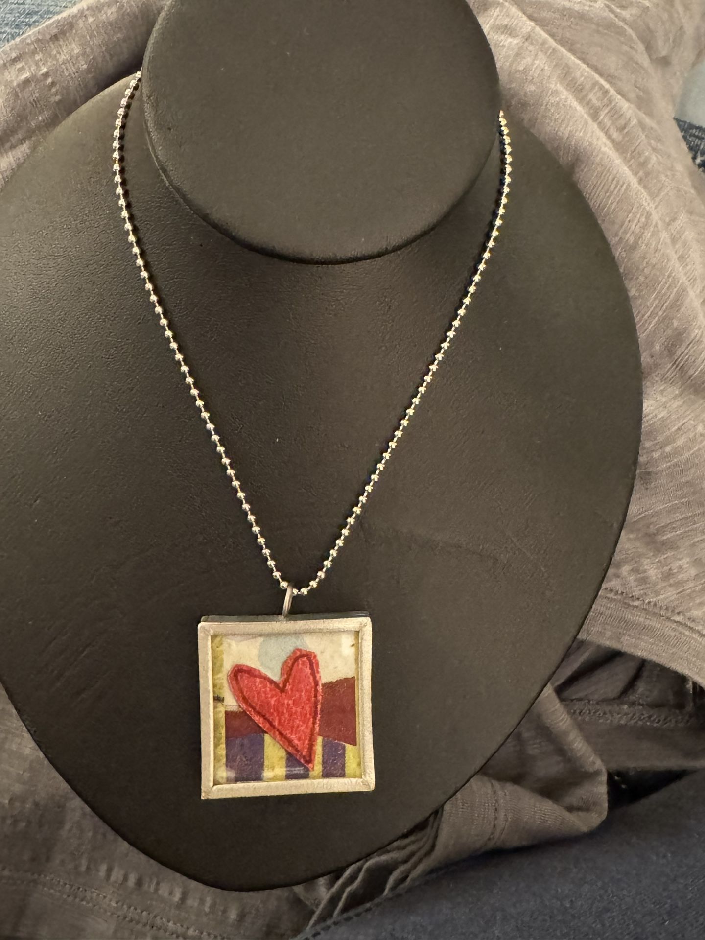 Reversible square glass art incased in a silver frame necklace - 23” length