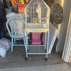 White Clean Rolling Bird Cage  Separate So You Can Take The Bird On Your Patio With You. 35 Cash Has The Perch The Water Dispenser And The Feeder Box