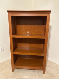 Used Cinnamon Cherry Colored Bookcase (28 inches x 48 inches x 13 1/2 inches)