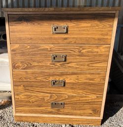 chest of drawers with brass-accented hardware. 