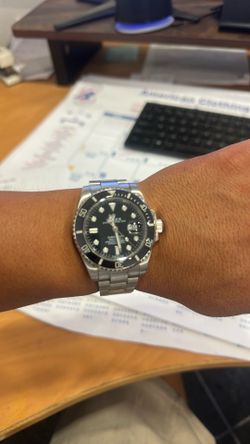 This is a Rolex Submariner Date, typically featuring a 41mm Oystersteel case and a black Cerachrom ceramic bezel