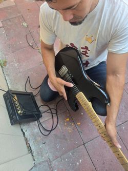 Black Electric Guitar with Small Amp
