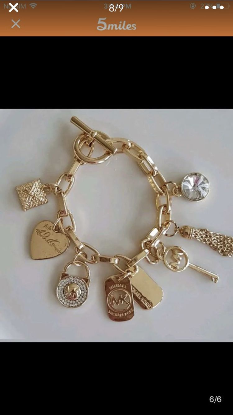 Mk Michael kors gold tone charms bracelet jewelry accessory