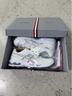 Browne x ASICS GEL-Kayano 14 in white features crisp mesh upper layering highlighted by signature red, white, and blue grosgrain ribbon detailing.