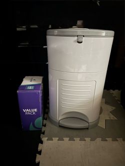 Lot with Dekor diaper pail with 5 refills, dr brown bottles, bin full of unused diapers, moby wrap