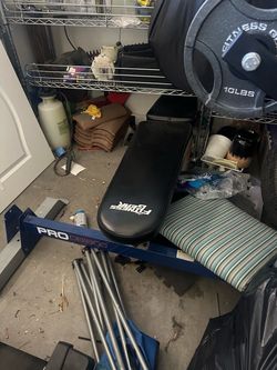2  weight  benches with weights and a Olympic bar and easy curl bar
