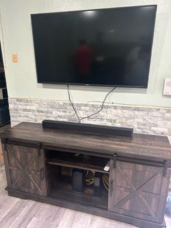 Tv stand with Sound bar and TV
