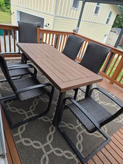 Outdoor patio table with chairs and rug